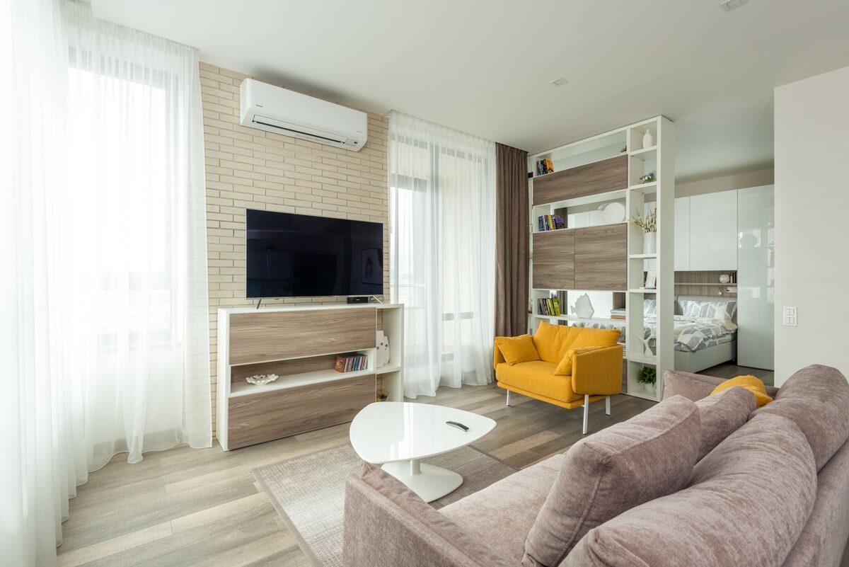 Bright modern lounge with cream sofas and teak detailing